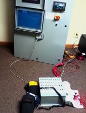 The simulator (foreground) attached to a cabinet.